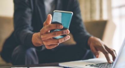 a business person working on laptop and mobile phone