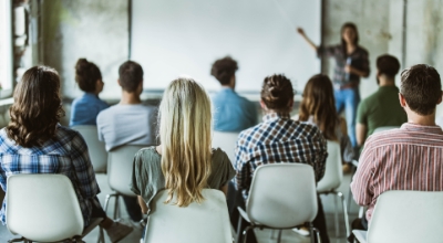 a classroom of professionals learning from presenter